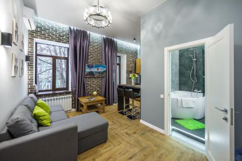 a living room with a couch and a sink at Pushkinskaya Apartments in Kyiv