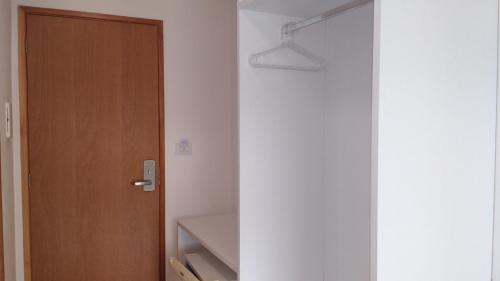 a room with a door and a closet with a light at Thermas Hotel in Salgadinho