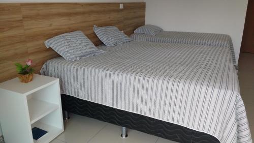 a bed in a room with a white cabinet at Thermas Hotel in Salgadinho