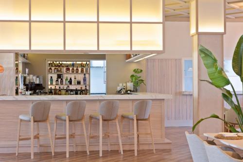 a bar in a restaurant with four stools at Melia Villaitana in Benidorm