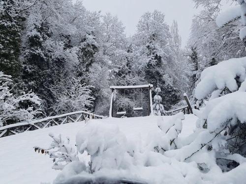 a snow covered area with a gate and trees at Hotel Ristorante Mulino Iannarelli in San Severino Lucano