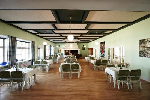 a banquet hall with white tables and chairs at Rødvig Kro og Badehotel in Rødvig