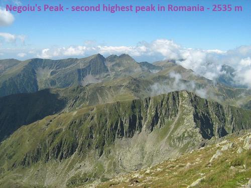 a view of a mountain with smoke on it at Pensiunea Flora in Cîrţişoara