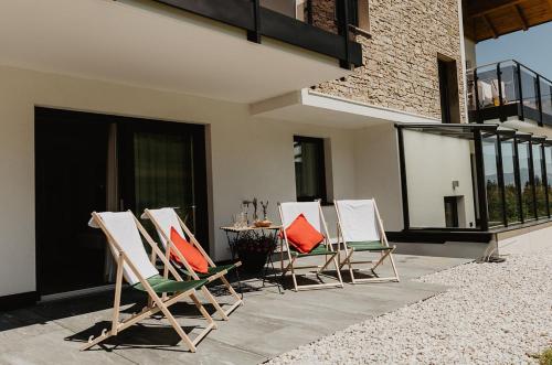 a group of chairs and a table on a patio at Appartements Almnest in Schladming