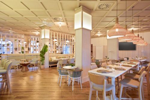 a restaurant with tables and chairs in a room at The Level at Meliá Villaitana in Benidorm
