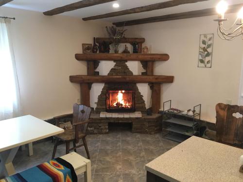a living room with a fireplace in the wall at EcoLodge in Novoselitsa