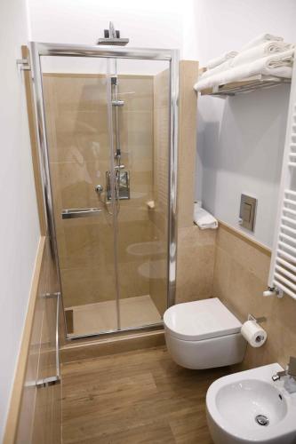 a bathroom with a shower and a toilet and a sink at 50 SUITE Guesthouse in Naples