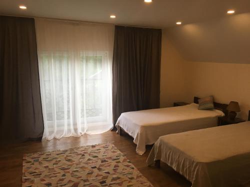 a hotel room with two beds and a window at EcoLodge in Novoselitsa