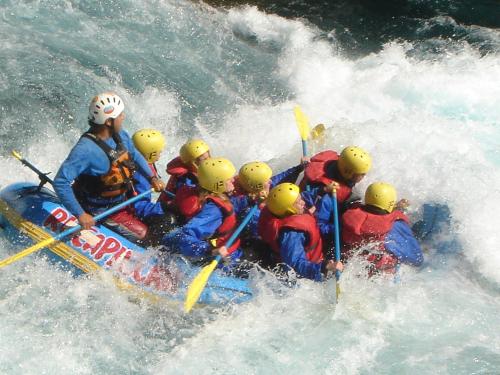 a group of people in a raft in the water at Hosteria-Cabañas Rucapillan in Choshuenco