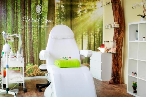 a hair salon with a tree mural at Holzschuhs Schwarzwaldhotel in Baiersbronn
