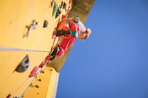 a man is climbing a rock wall at lintharena ag in Näfels