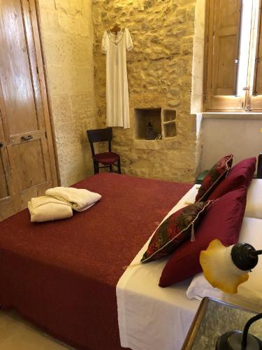 a bedroom with a bed and a robe hanging on a wall at Borgoincorte in Martano