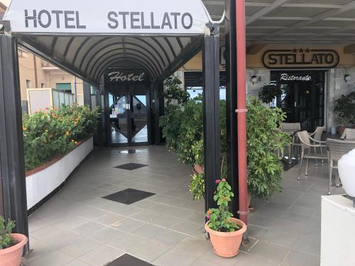 an entrance to a hotel stall with plants in pots at Hotel Ristorante Stellato in Trebisacce
