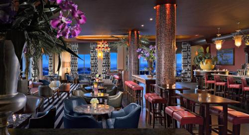 a restaurant with tables and chairs and flowers at Salthill Hotel in Galway