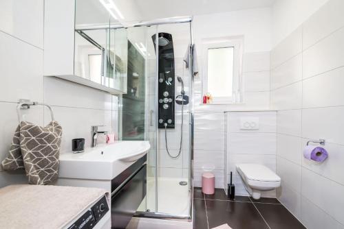 a bathroom with a shower and a sink and a toilet at Apartment NewCity in Novigrad Dalmatia