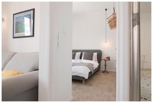 a living room with a bed and a couch at Stylish - Centre Apartment Theatre View in Rijeka