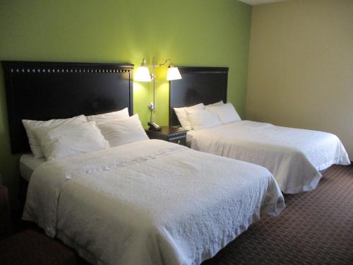 two beds in a hotel room with white sheets at Motel 6-Conway, AR in Conway