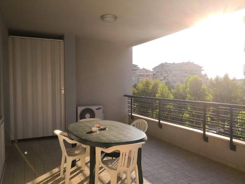 a table and chairs on a balcony with a view at Domus Aries Montesilvano in Montesilvano