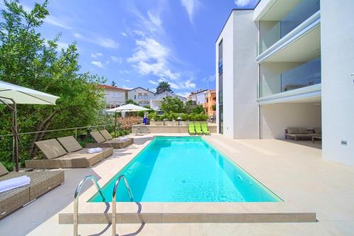 a swimming pool in the backyard of a house at Villa Celeia in Krk