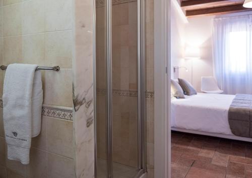 a bathroom with a towel hanging from the wall at Relais Madonna di Campagna in Bastia Umbra