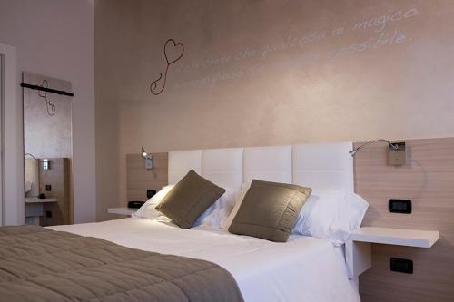 a hotel room with a bed and a lamp at Relais Madonna di Campagna in Bastia Umbra