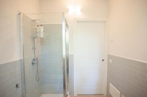 a shower with a glass door in a bathroom at Italianflat - Maison du Lac in Lazise