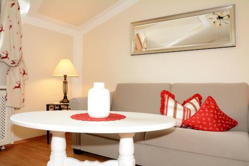 a living room with a couch and a table with pillows at Landhaus Notburga in Gries im Sellrain