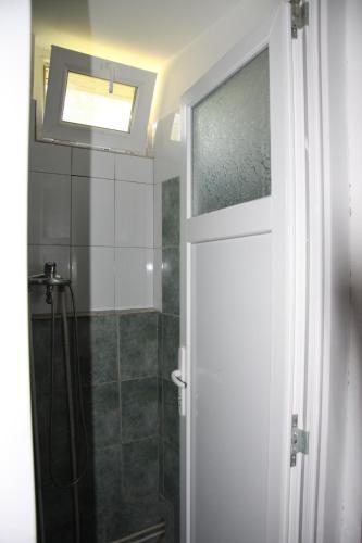 a bathroom with a shower and a glass door at La Cabana in Băile Herculane