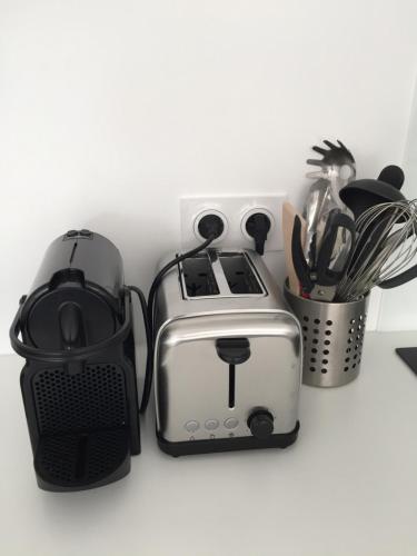 a toaster and other appliances on a counter at Corniche I 40 M2 - 40 M de l'eau et plages ! AU CALME wir sprechen flieBen deutsch, we speak English in Concarneau
