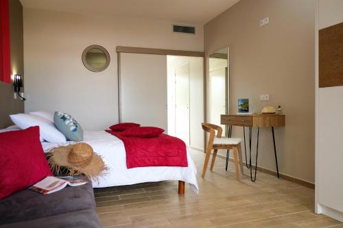 a bedroom with a bed with a red blanket at Diamant les bains - Résidence Hôtelière in Le Diamant