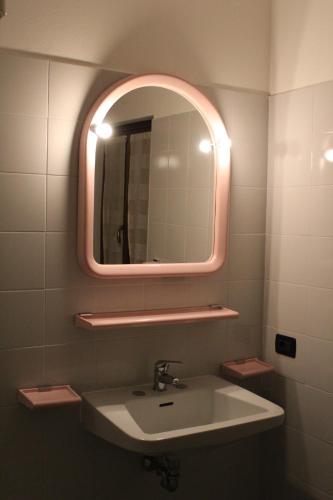 a bathroom with a sink and a mirror at albergo ristorante le fontane in Gargnano