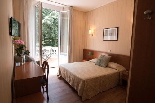 a hotel room with a bed and a window at Hotel Villa Delle Rose in Rome