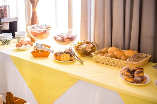 a table topped with baskets of bread and eggs at Mon Repos Hotel in Faliraki
