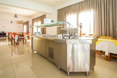 a kitchen with a counter in a restaurant at Mon Repos Hotel in Faliraki