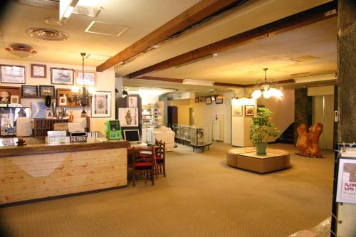 a store with a counter and chairs in a room at Villa Alpen in Yamanouchi
