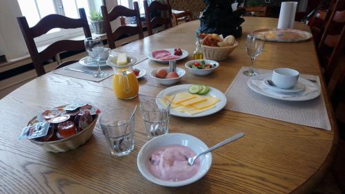 a wooden table with food and drinks on it at B&B Pickery in Bruges