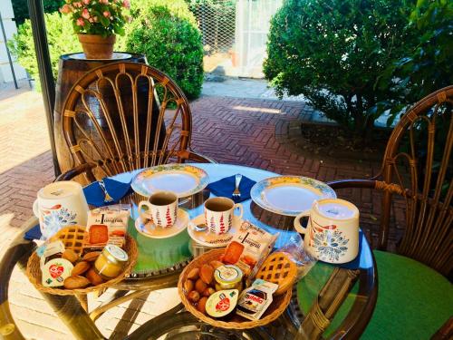 a table with a tray of food and cups of coffee at B&B San Paolo in Campagna