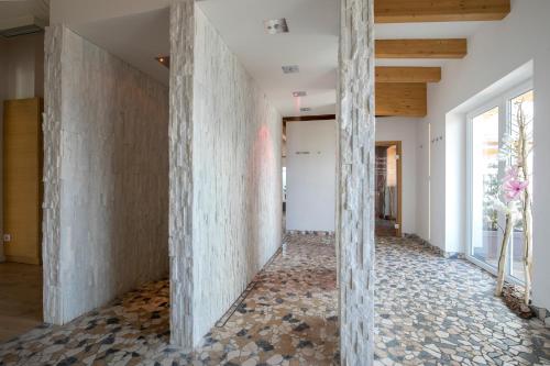 a hallway of a house with stone walls at Hotel Luna Bianca Folgaria in Folgaria