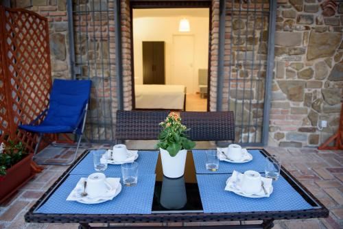 a table with plates and napkins on a patio at Maelka Belvedere in Agropoli