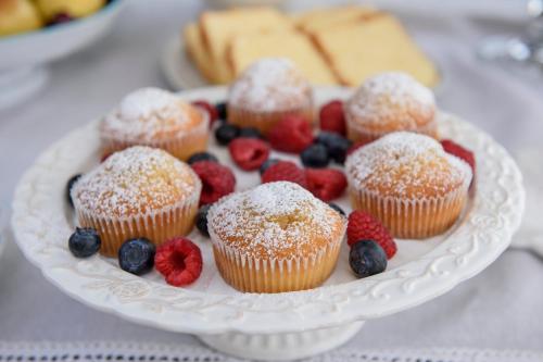 a plate of muffins and berries on a table at Maelka Belvedere in Agropoli