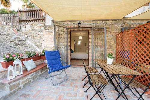 a patio with a blue chair and a table at Maelka Belvedere in Agropoli