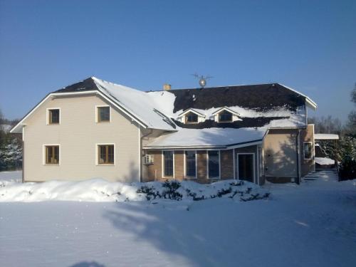 a white house with snow on the roof at U nových přátel in Lichkov