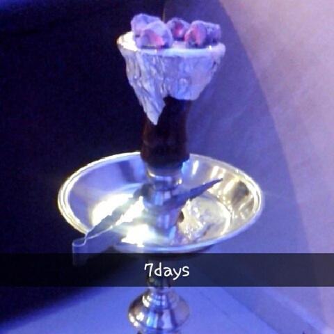 a glass vase with candy in it on a plate at Seven Days Hotel in Irbid