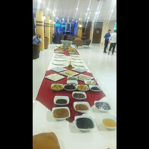 a long table filled with different types of food at Seven Days Hotel in Irbid