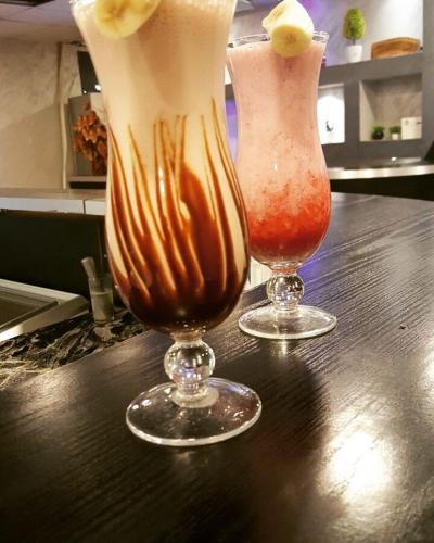 two drinks in vases sitting on a table at Seven Days Hotel in Irbid