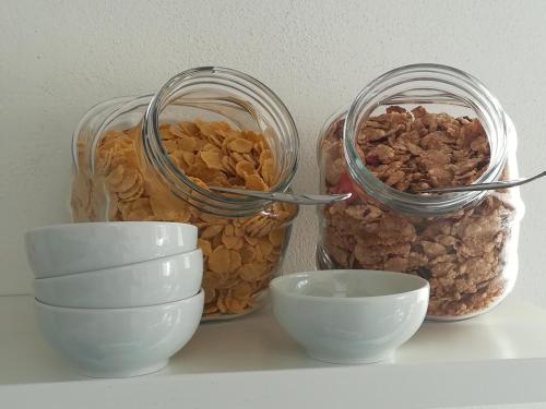 a group of glass jars and bowls on a shelf at Domus Fortunae B&B in Bacoli