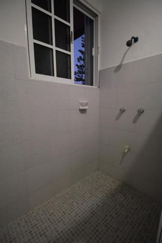 a bathroom with a shower with a window at Villas Roseliz in Punta Allen