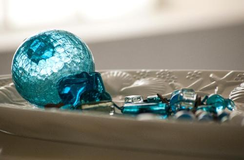 a blue glass egg on a plate with crystals at Villa Serenity in Porto Rafti
