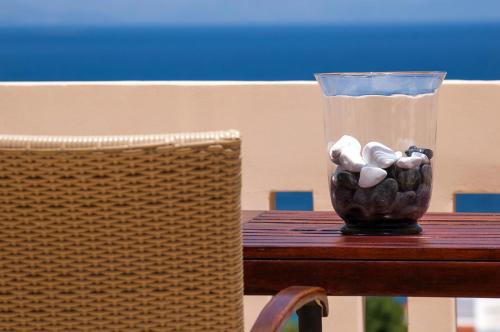 a vase with rocks in it sitting on a table at Villa Serenity in Porto Rafti