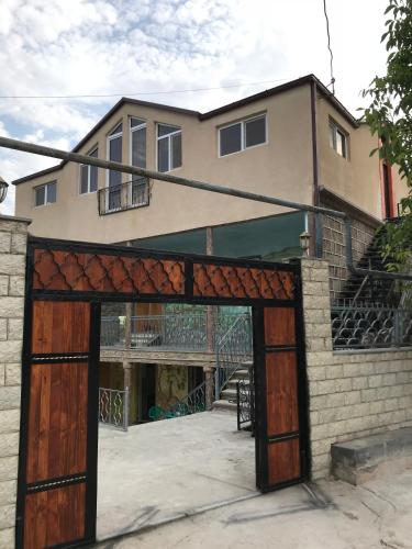 a house with an open garage in front of it at COMMUNE hotel in Garni